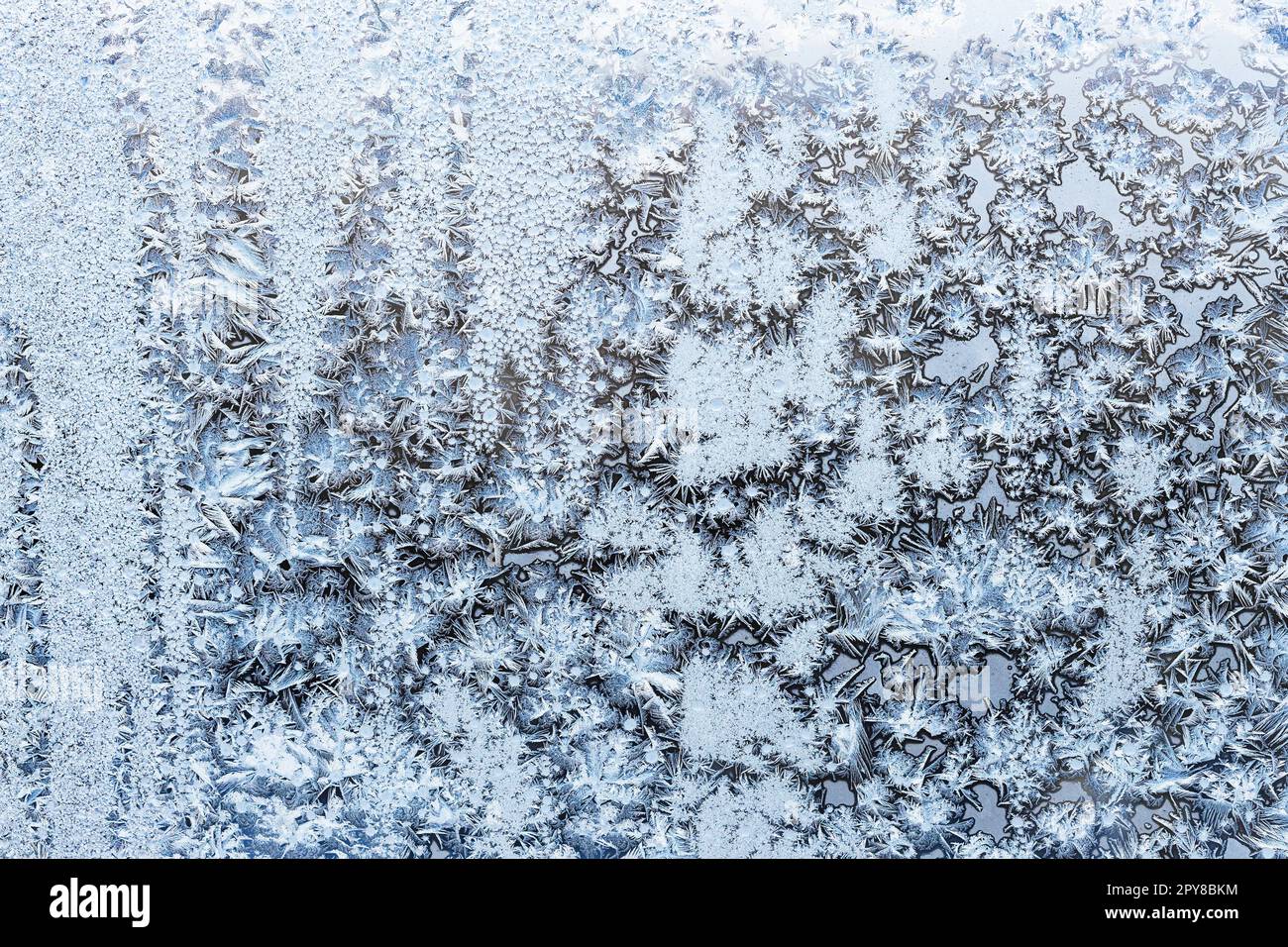 blue frost on surface on home window glass closeup Stock Photo - Alamy