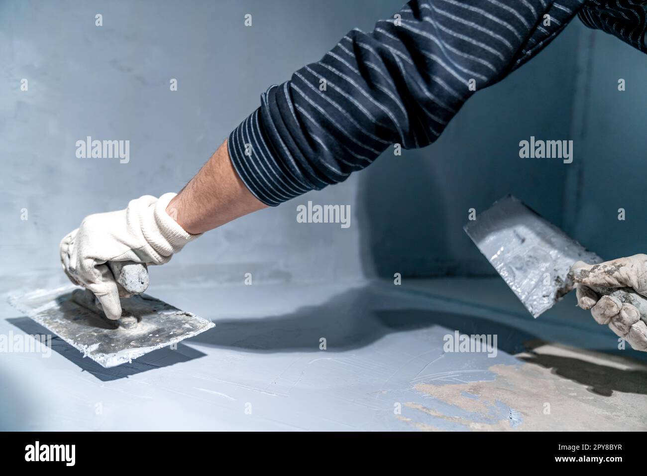 construction modifications of the floor and walls with trowel of a room ...