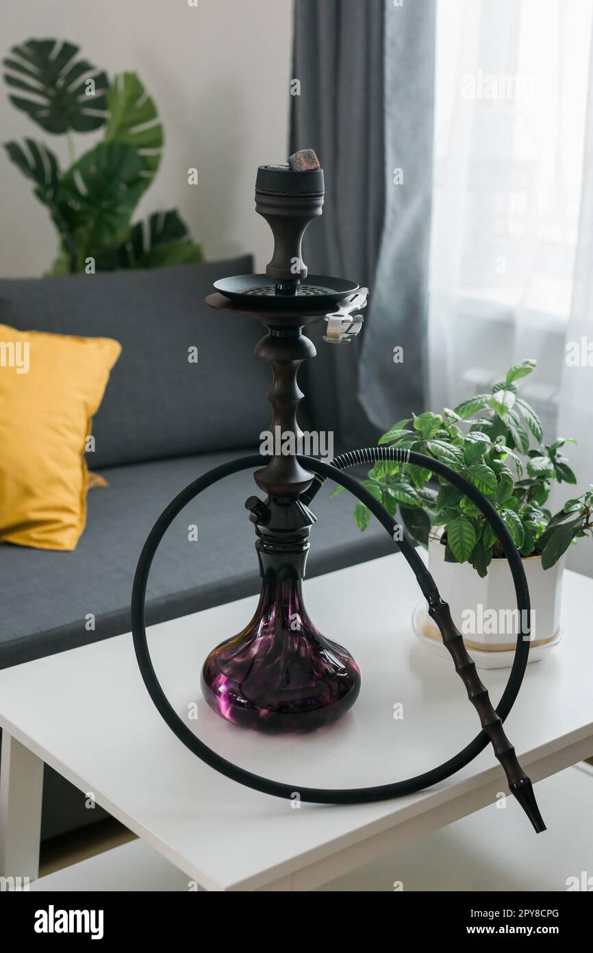 Shisha hookah bowl with red hot coals and craft tobacco. Modern hookah