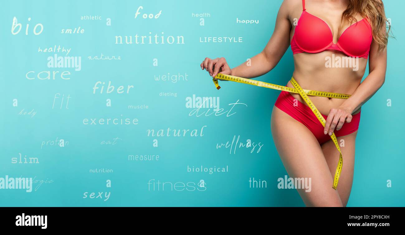 Girl measures with the meter the diet results. Happy and joyful expression. Cyan background with diet terms Stock Photo