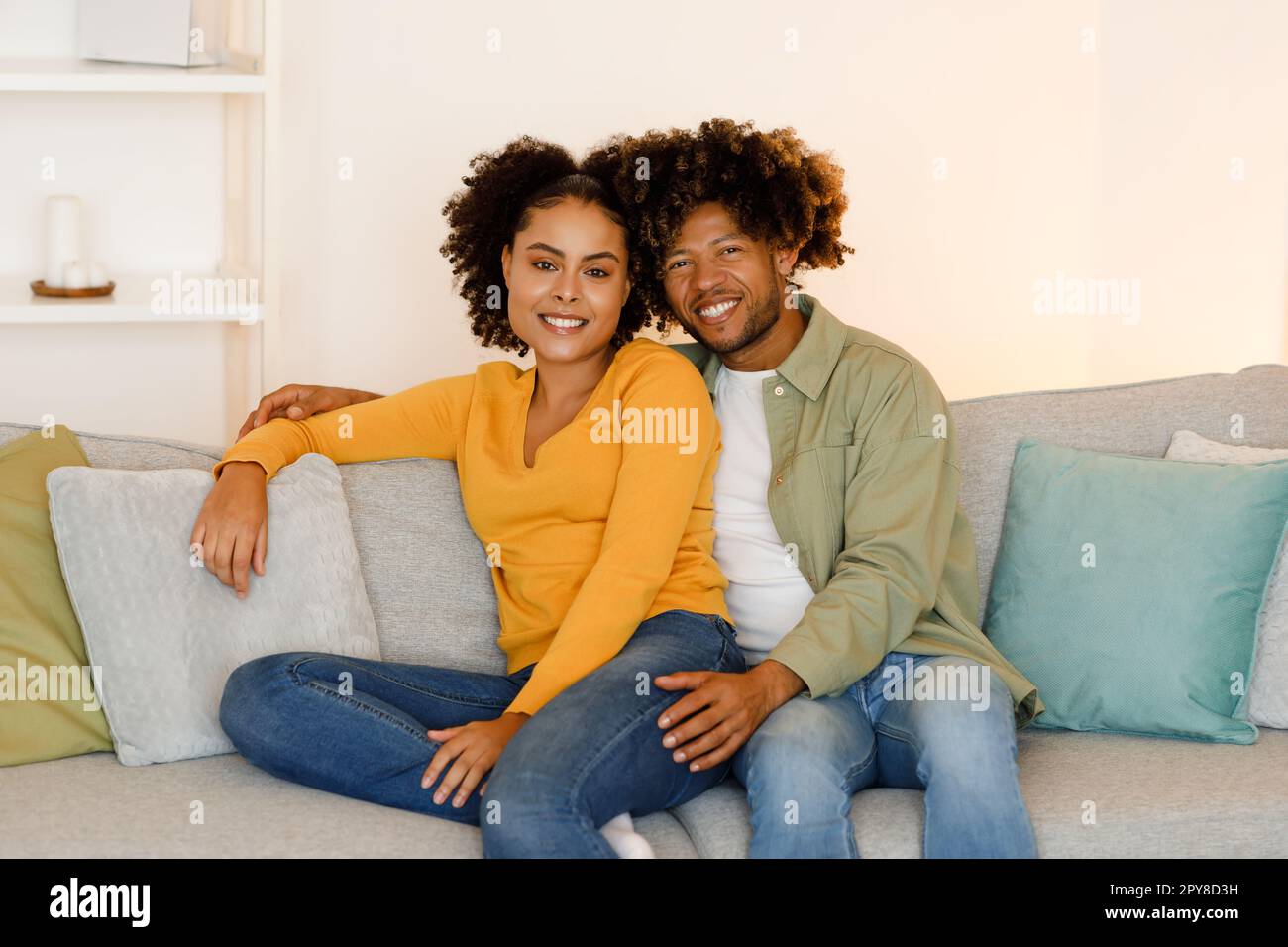 Happy African American Spouses Embracing Posing On Sofa At Home Stock ...