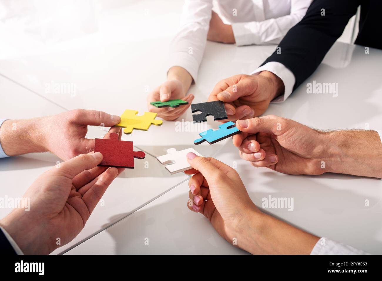 Teamwork of partners. Concept of integration and startup with puzzle pieces Stock Photo