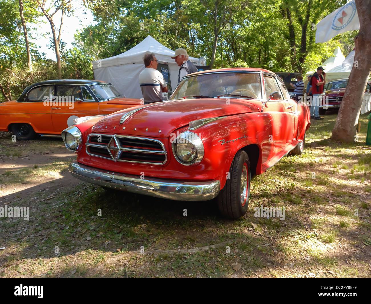 San Isidro, Argentina - Oct 7, 2022: Old red 1960s Borgward Hansa Isabella coupe in a park. Nature, grass, trees. Autoclasica 2022 classic car show. Stock Photo