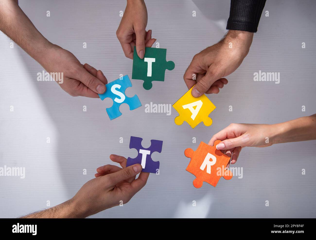 Teamwork of partners. Concept of integration and startup with puzzle pieces Stock Photo