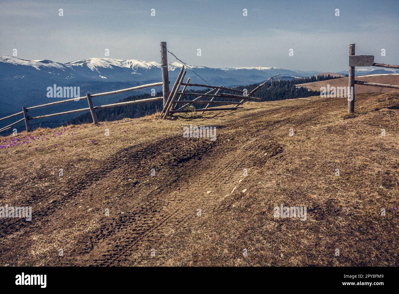 Log fence at hill pastureland landscape photo Stock Photo