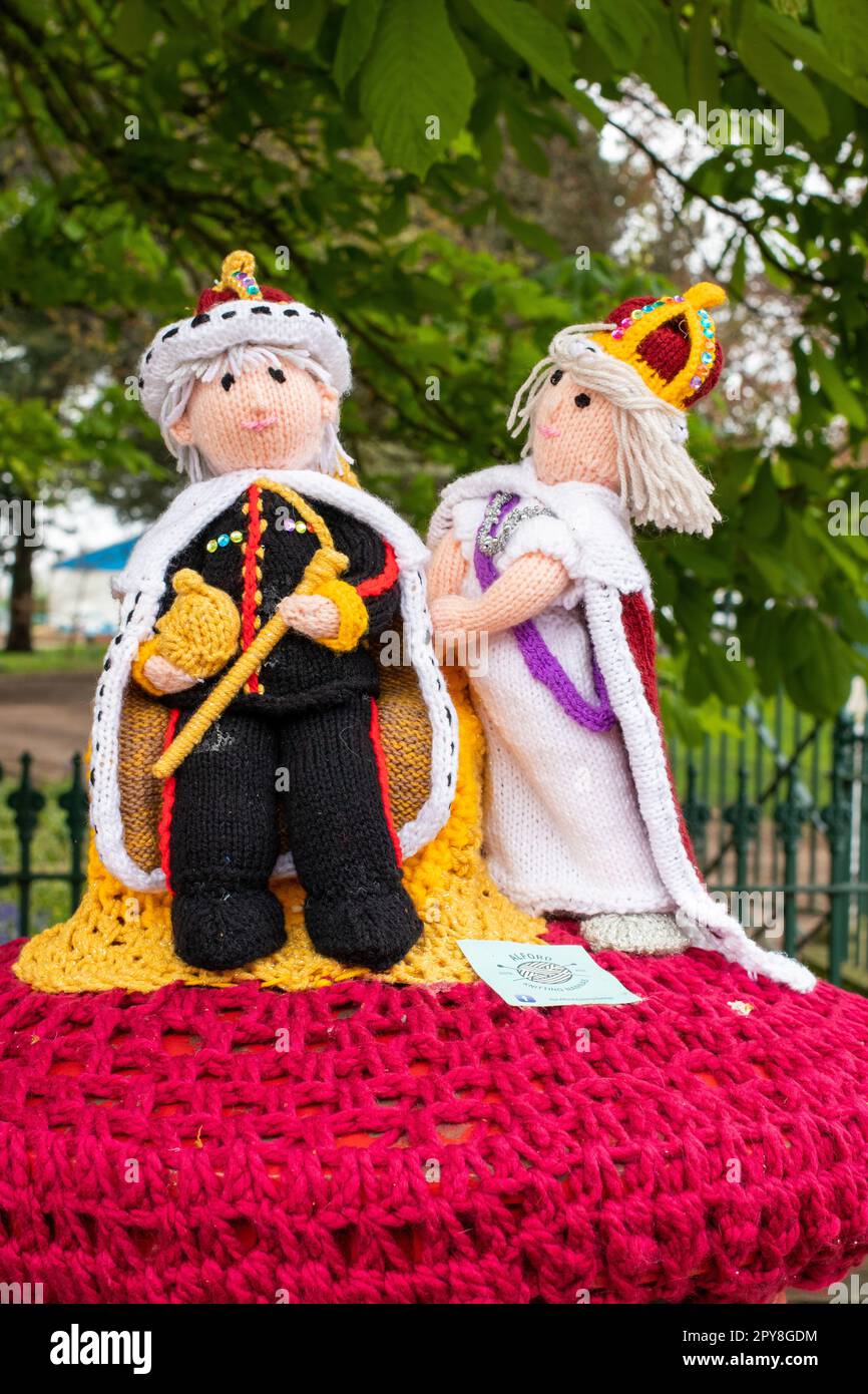 The post box in West Street, Alford, decorated with knitted wool in preparation for the Coronation. This type of decoration is called Yarn bombing. Alford in Lincolnshire prepares for the Coronation of King Charles III. Stock Photo