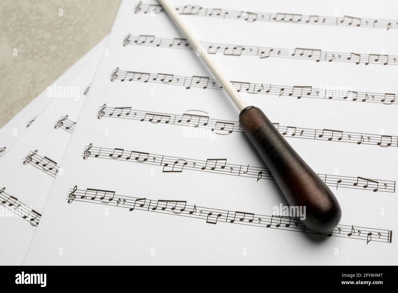 Conductor's baton and sheet music on grey background Stock Photo Alamy