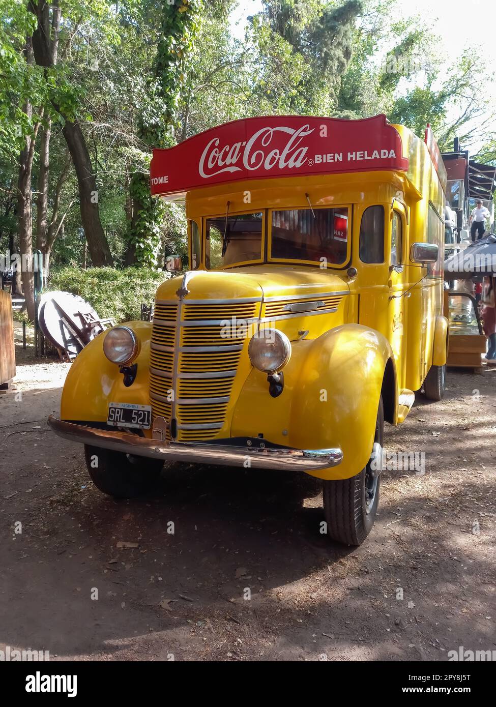 Vintage old yellow 1930s International Harvester Coca Cola delivery truck in a park. Logo and branding. Autoclasica 2022 classic car show Stock Photo