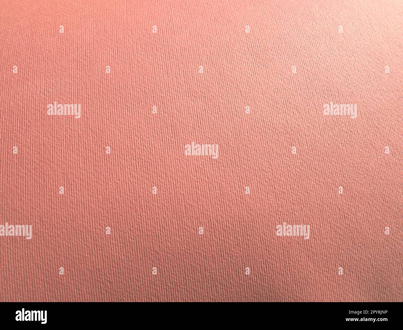 Abstract pink background with texture. Close-up of paper surface with light and color gradient. Side lighting. Soft pastel peach or ruddy tone backdrop. Stock Photo