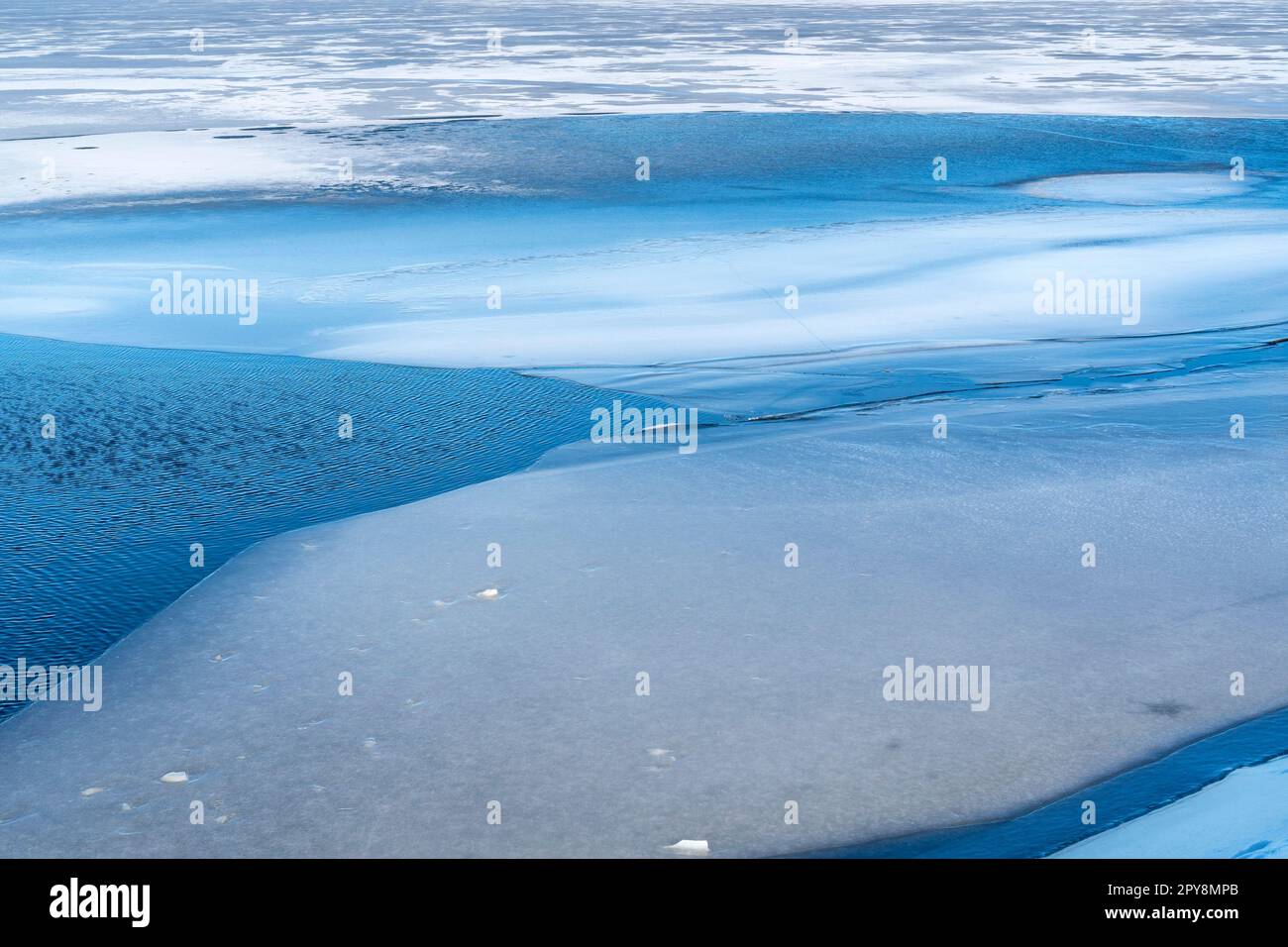 Holes of melting ice on the lake Stock Photo