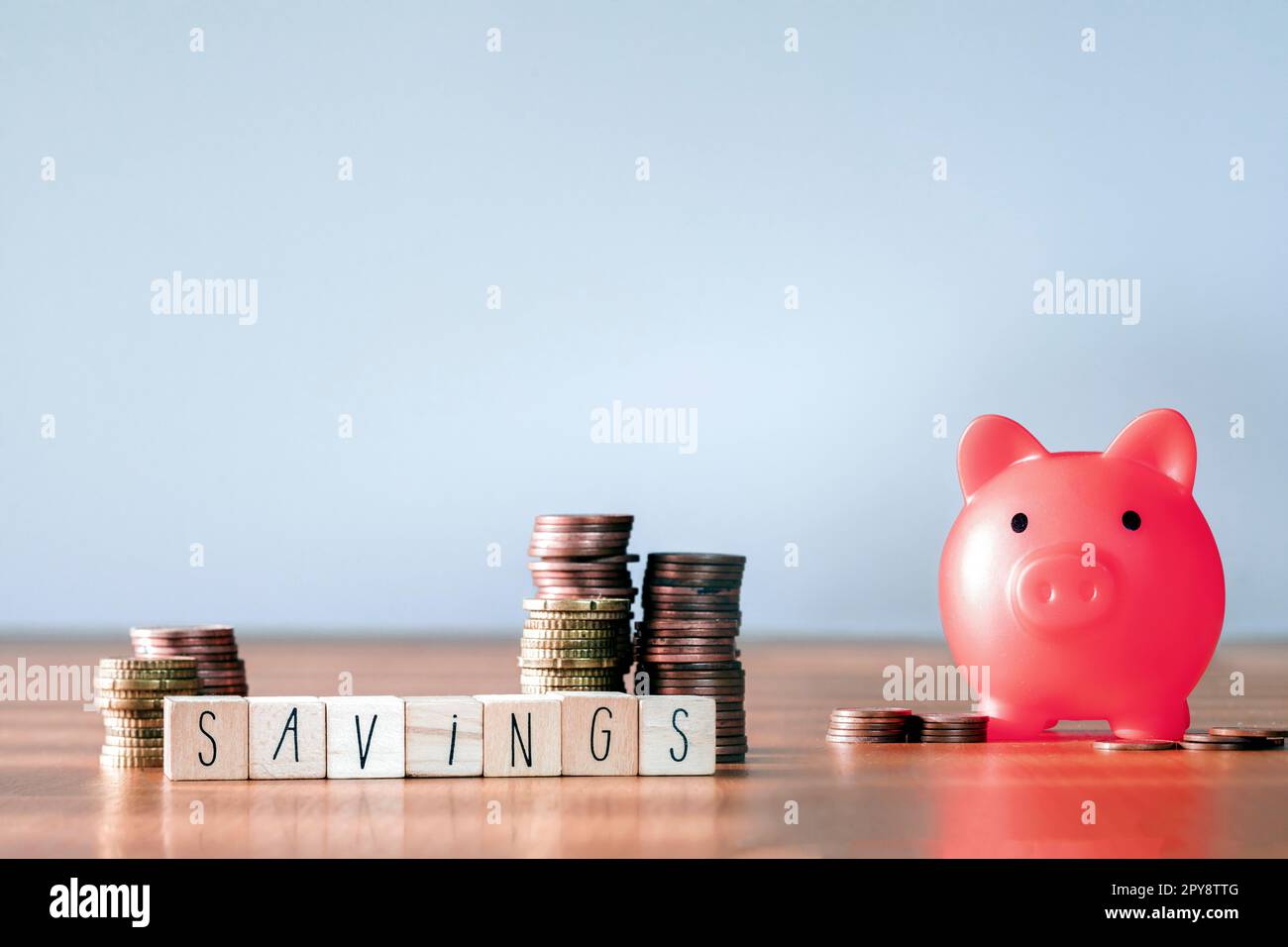 Stack of coins with gray background and copy space. saving money and financial plan concept for investment in new year 2023. pink piggy bank Stock Photo