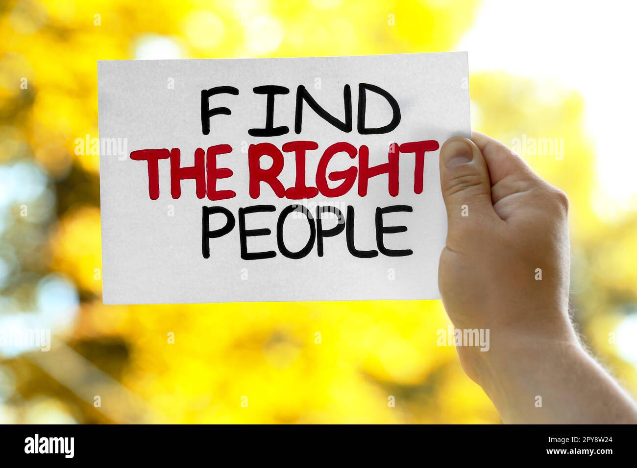 Man holding card with phrase Find The Right People against blurred background, closeup Stock Photo