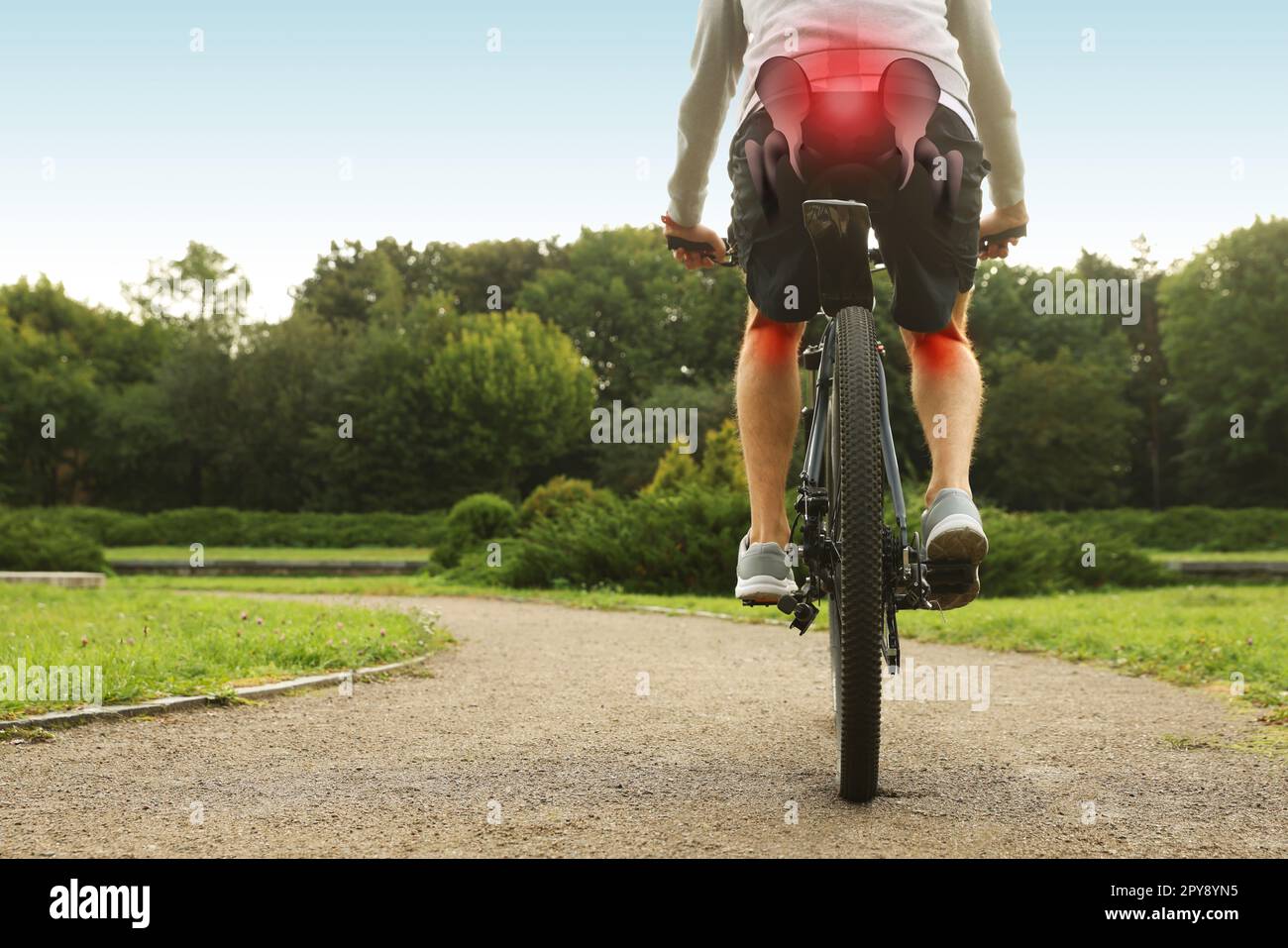 Problem of injured coccyx. Man riding bicycle on road Stock Photo Alamy