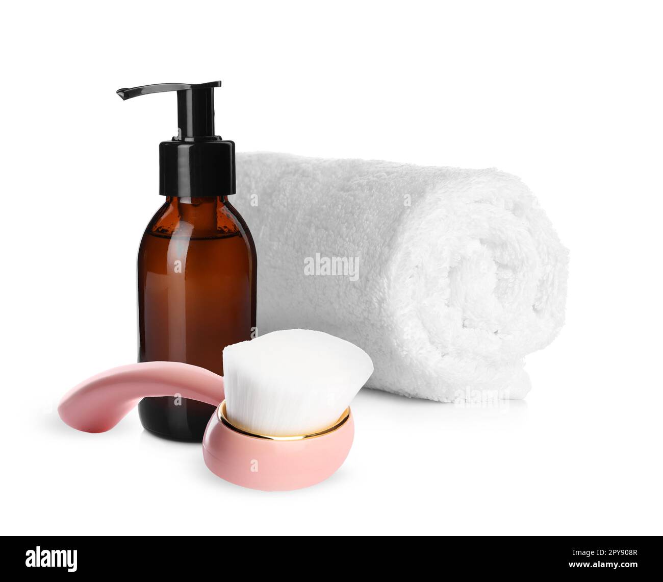 Rolled clean towel, bottle of hydrophilic oil and face cleansing brush