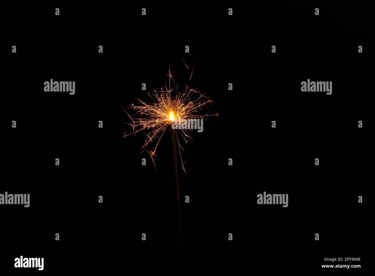 One burning sparkler stick on black background Stock Photo