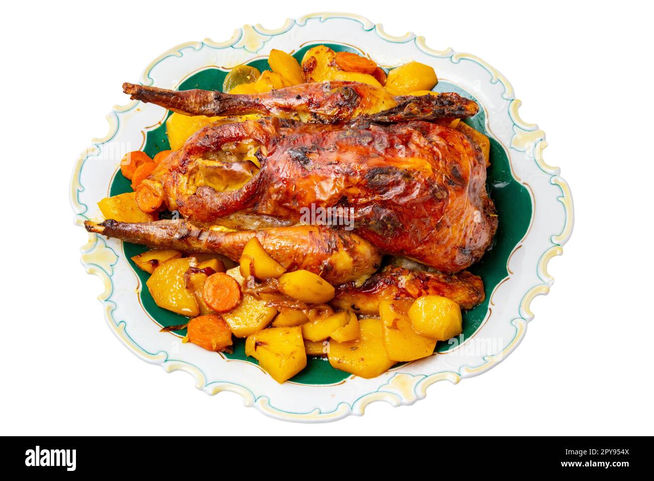 Grilled whole guinea fowl or baked pearl chicken on roasted potatoes and vegetables and port wine sauce is served on a beautiful plate. Clipping path. Isolated on white. Stock Photo