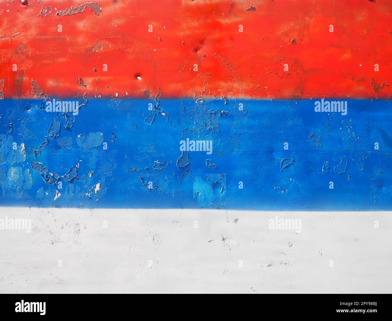 Serbian flag, tricolor red, blue, white painted on a metal surface. Peeling paint Stock Photo