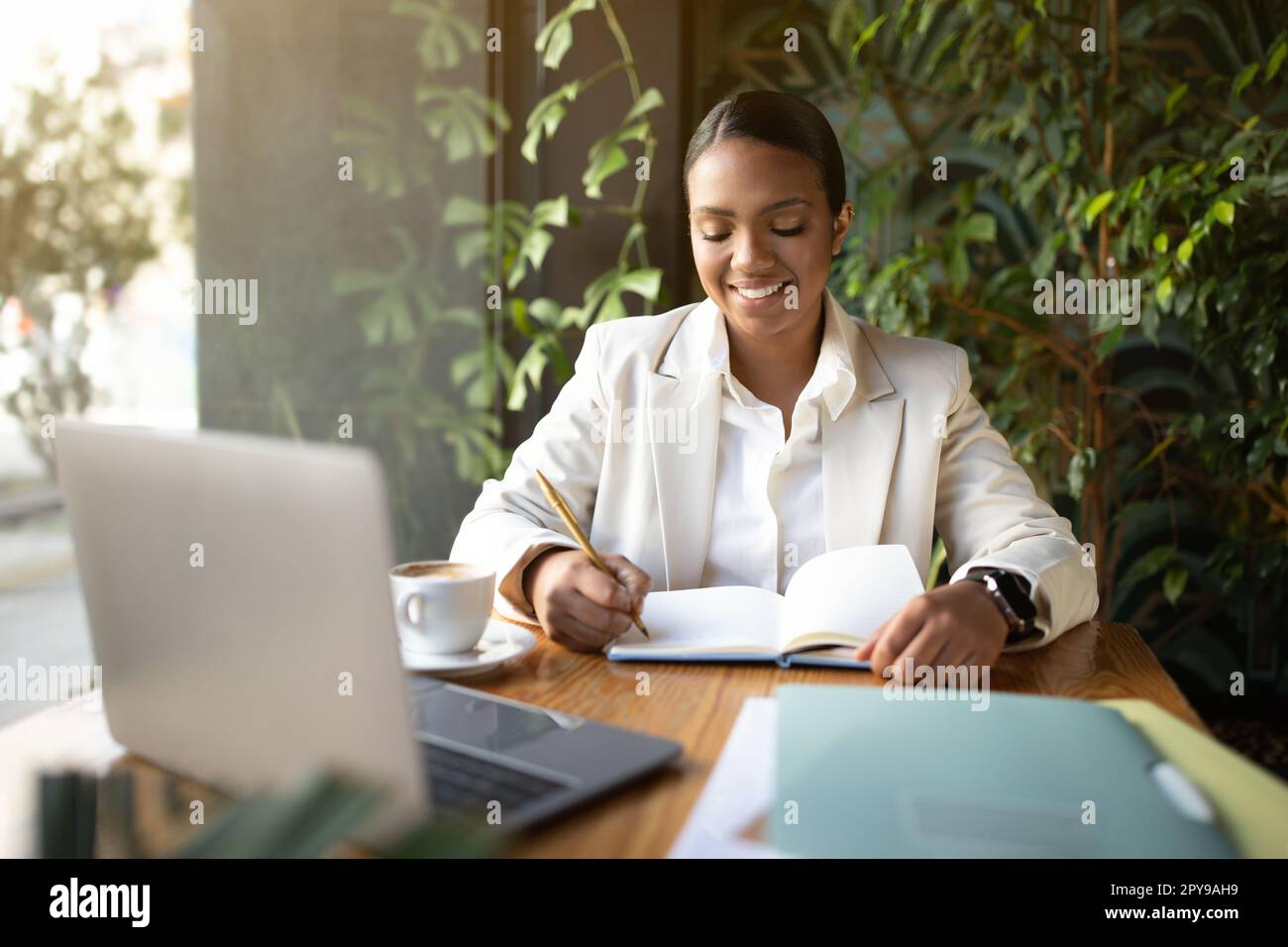 Positive black lady planning hi-res stock photography and images - Alamy
