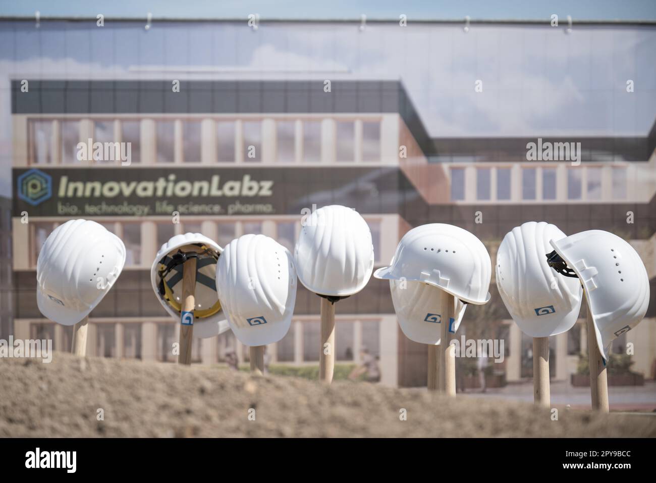 Mainz, Germany. 03rd May, 2023. Spades and helmets stand after the groundbreaking ceremony for the kick-off building, the laboratory and office building 'LAB 1', of the new biotech and life science site near the university on the site. Credit: Sebastian Christoph Gollnow/dpa/Alamy Live News Stock Photo
