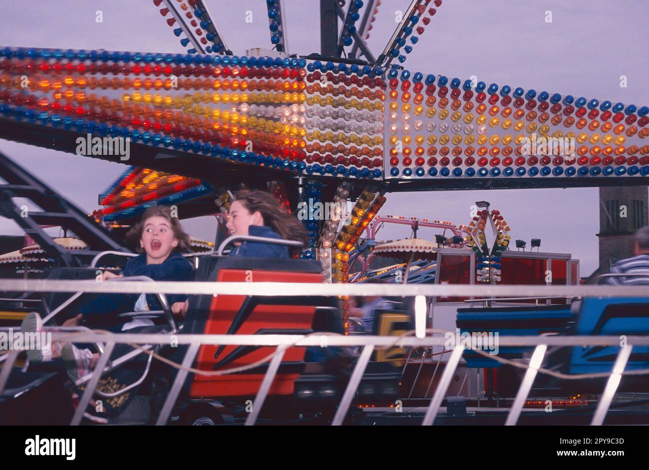 Funfair on Helensburgh seafront, Scotland with children on twister. Stock Photo