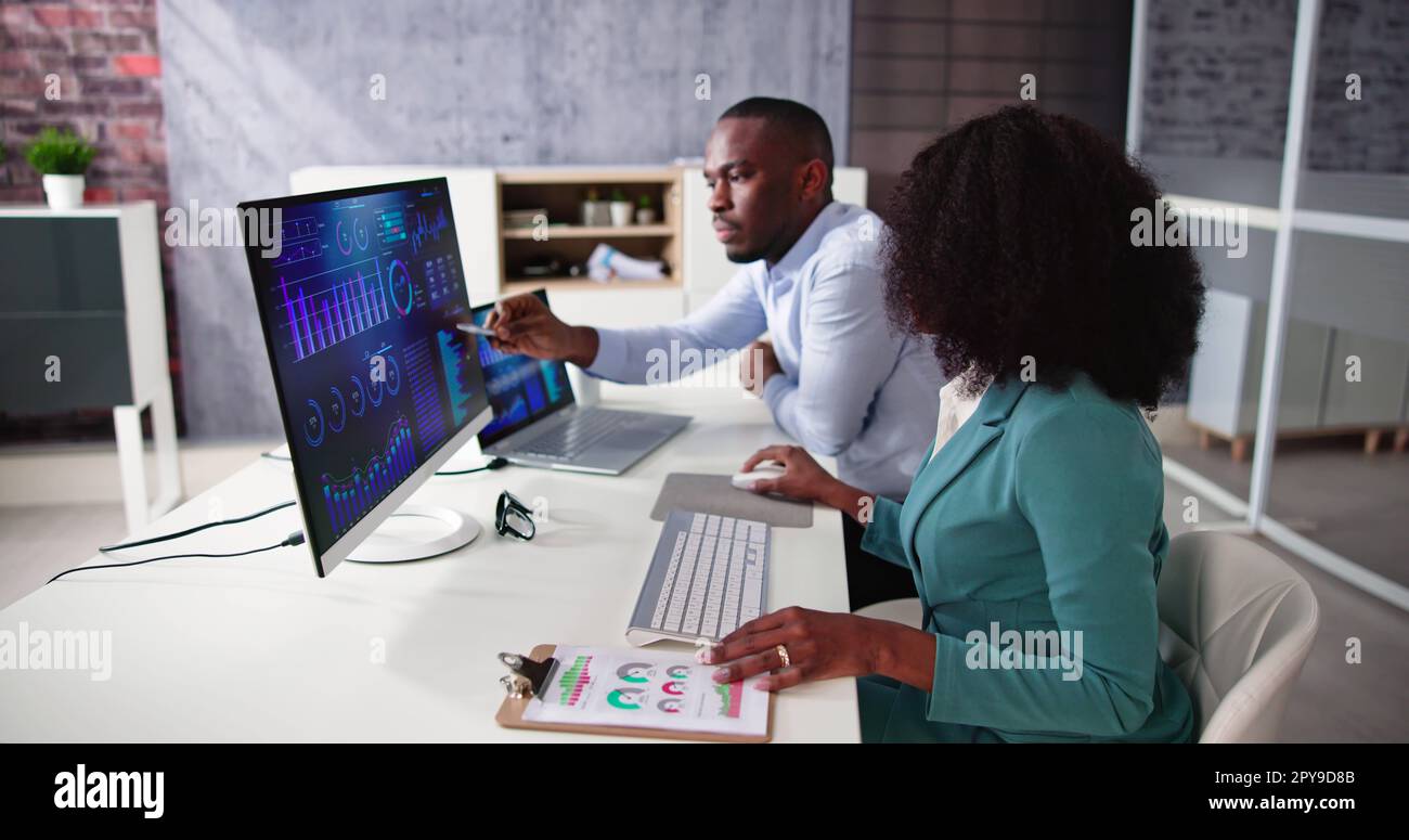 African American Analyst Using Financial Business Data Stock Photo