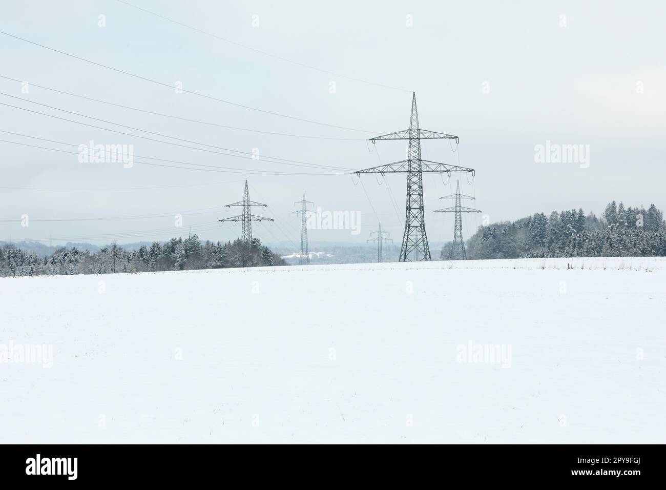 Electrical towers in winter landscape Stock Photo