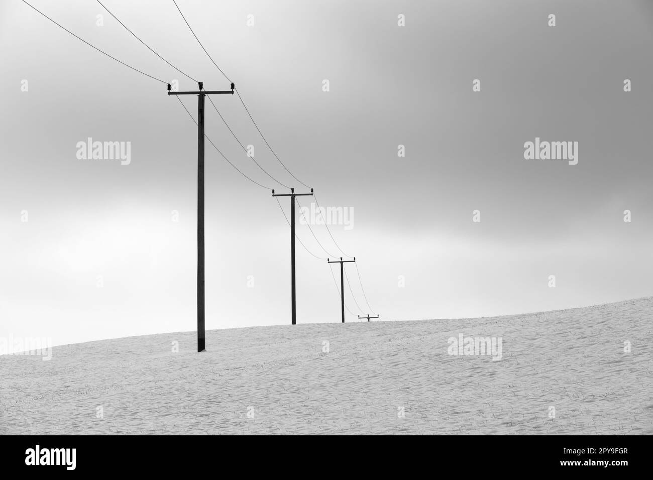 Electrical towers in winter landscape Stock Photo