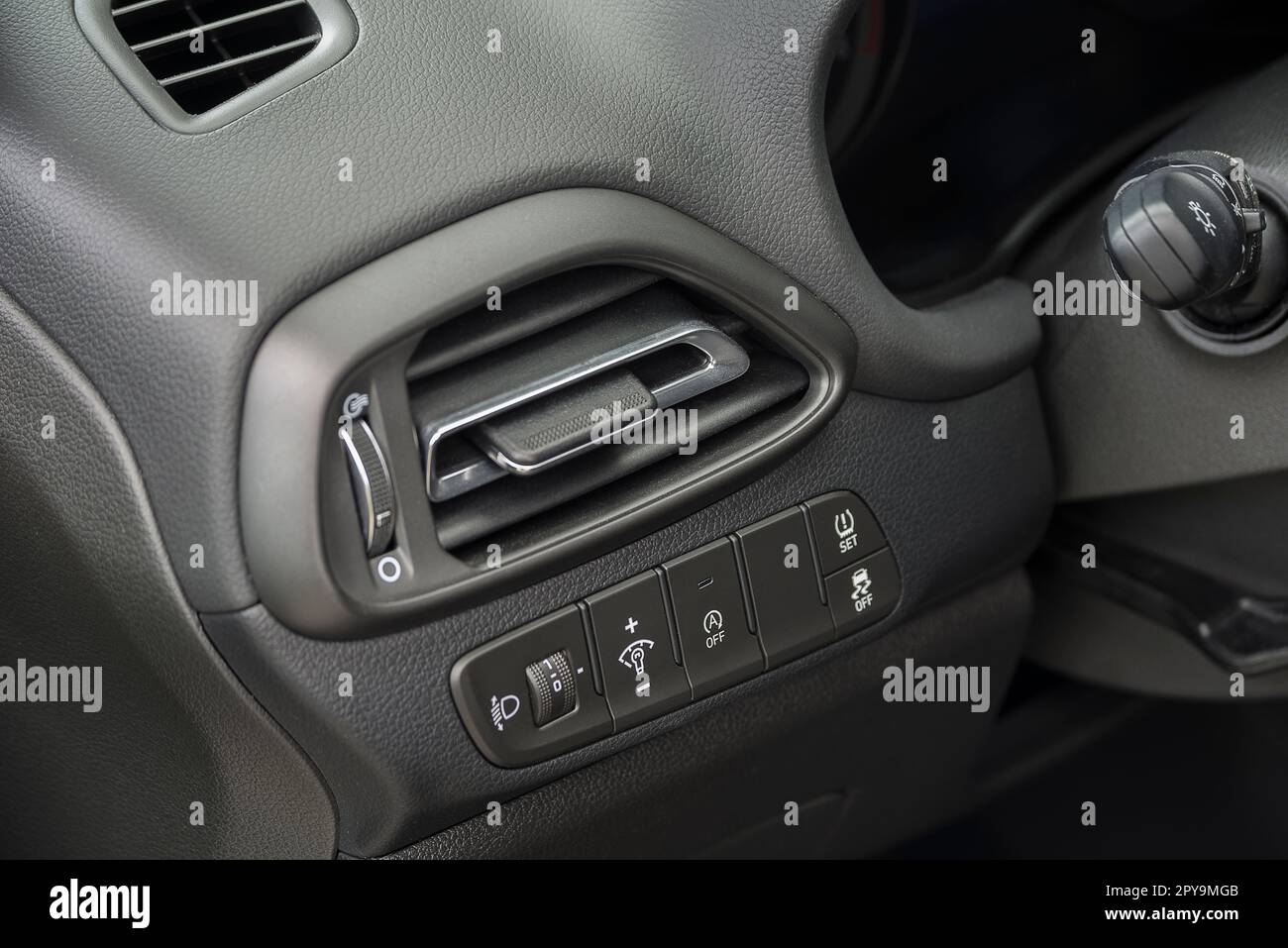 Air vent grill in a car. Air conditioner grid and control panel buttons