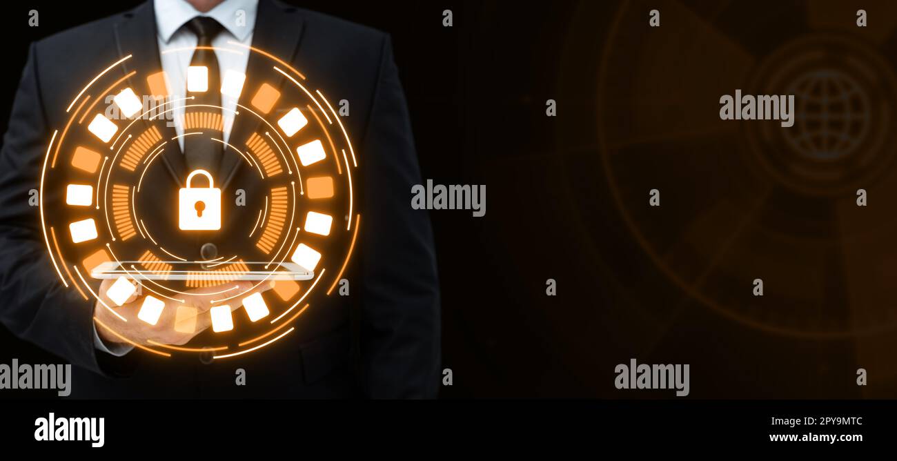Man in suit holding tablet with one hand. Glow going from device presenting important information. Futuristic digital design showing technological system. Stock Photo