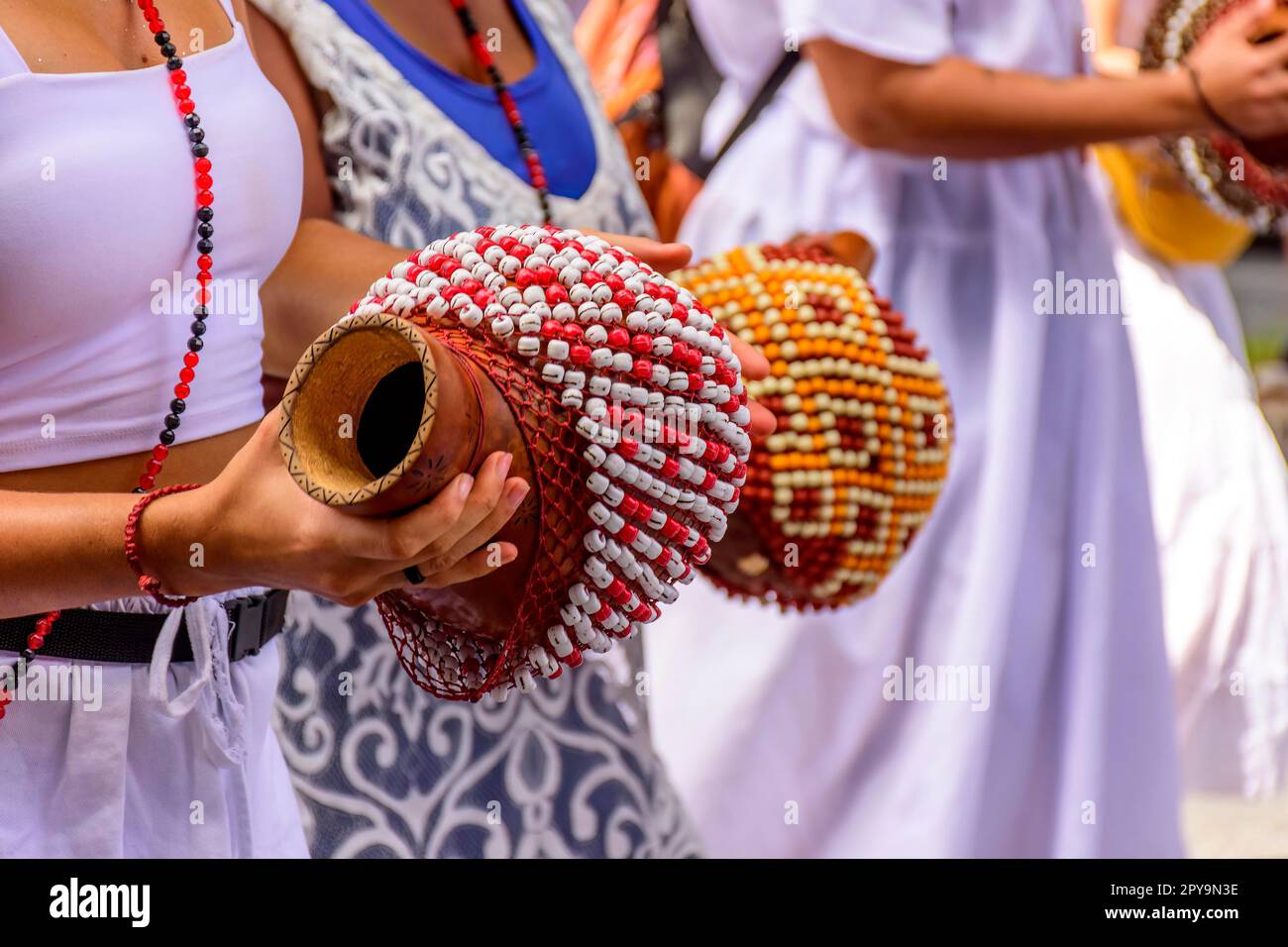 Brazilian Rattle Woman playing a type of rattle called xereque of African origin used in ...