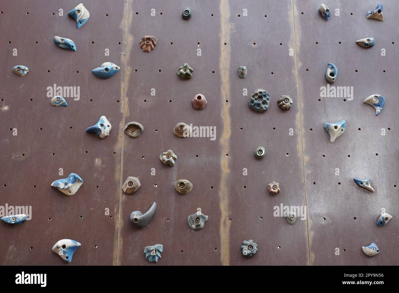 artificial climbing wall with a variety of holds Stock Photo