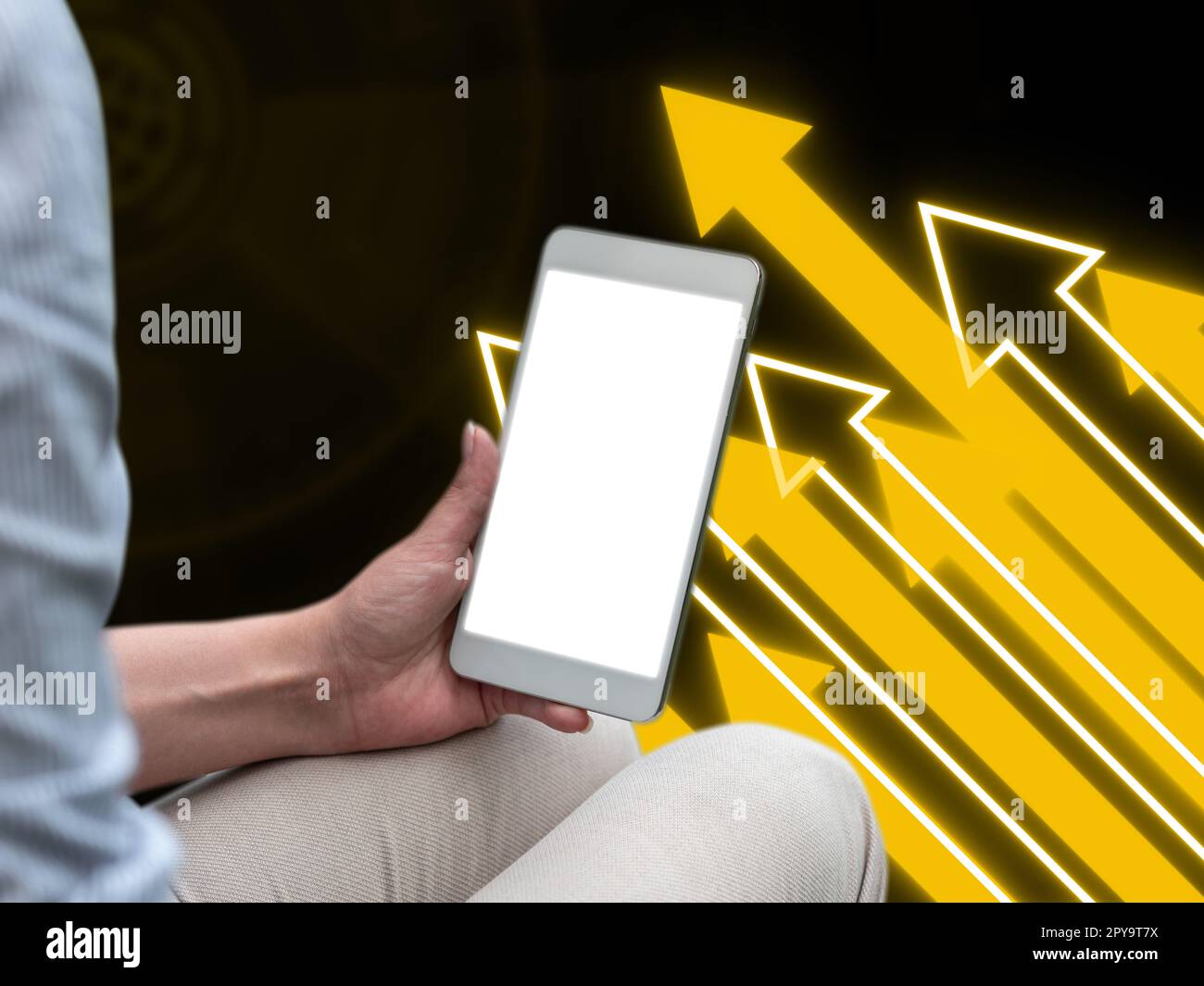 Person sitting and holding phone in one hand. Important information on the mobile phone display. Crllphone monitor glowing. Futuristic image with colored glow. Stock Photo