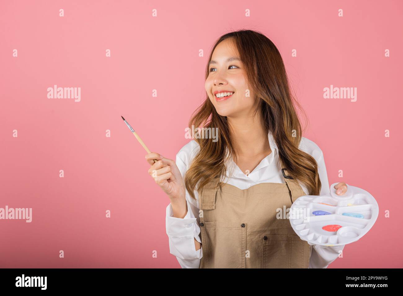 Asian beautiful young woman artist holding brush and paint palette Stock Photo