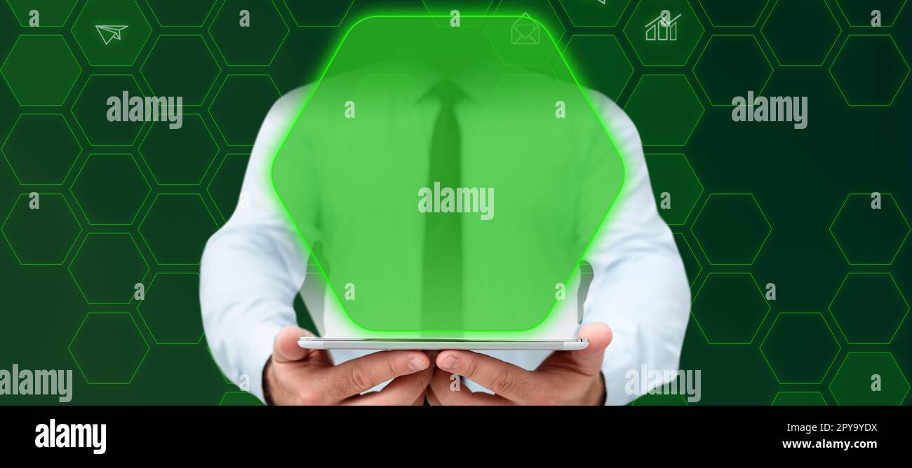 Businessman in office white shirt standing holding tablet in his hands. Glow from device screen presenting technological message. Futuristic style image with color glow. Stock Photo