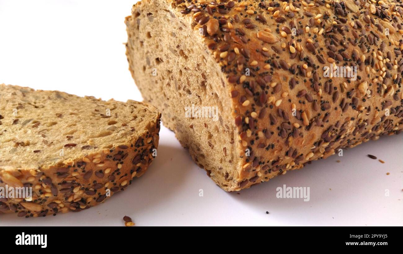Fresh rye bread cut into pieces. White background. Bread with bran and