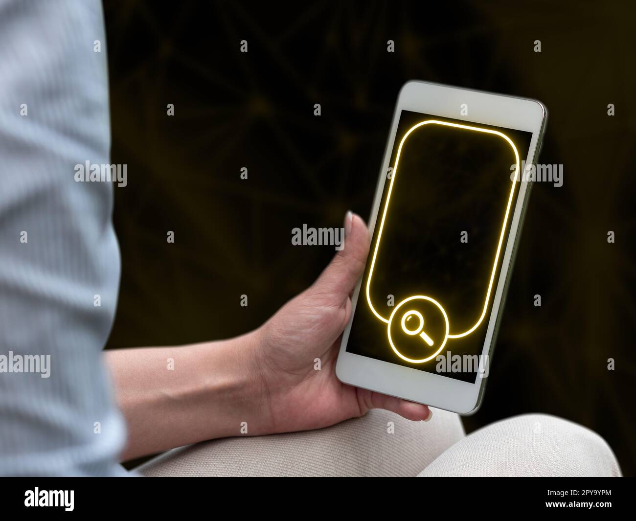 Person sitting and holding phone in one hand. Important information on the mobile phone display. Crllphone monitor glowing. Futuristic image with colored glow. Stock Photo
