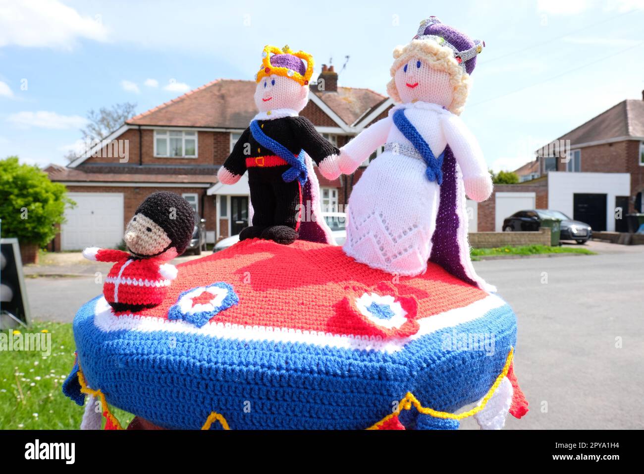 Hereford, Herefordshire, UK – Wednesday 3rd May 2023 – A woolly knitted King Charles III and Queen Camilla adorn a post box in suburban Hereford as Britain prepares for the King’s Coronation on Saturday 6th May 2023. Photo Alamy Live News / Steven May Stock Photo