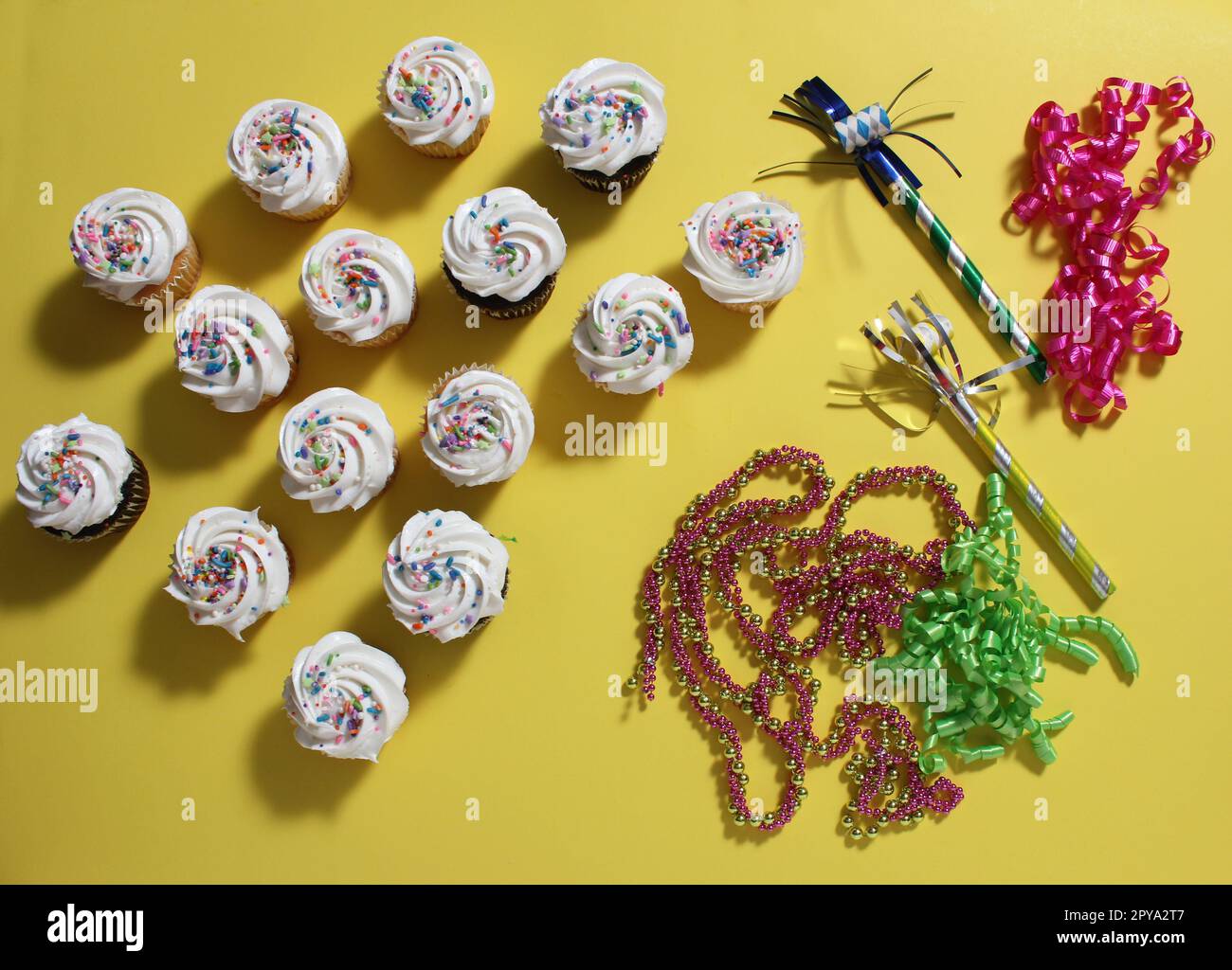 Cupcakes on Table at Party on Yellow Table Stock Photo