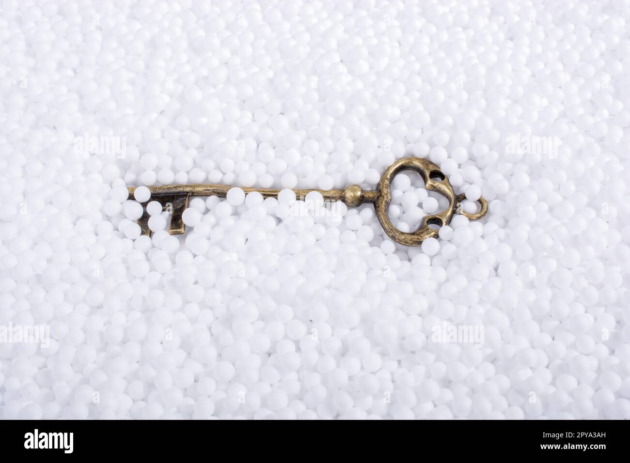 Retro key on little white polystyrene foam balls Stock Photo - Alamy
