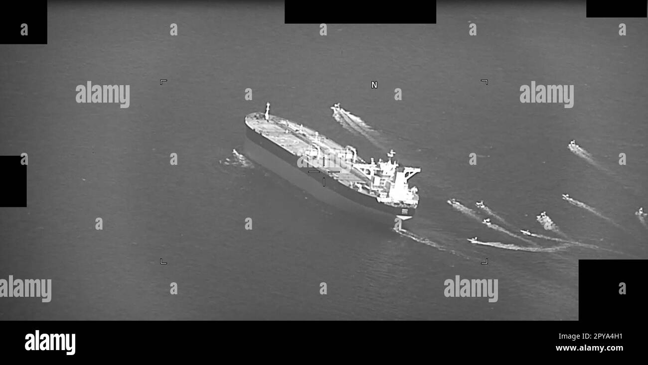 A video screenshot shows the Panama-flagged oil tanker Niovi during its seizure by Iran's Islamic Revolutionary Guard Corps Navy (IRGCN) while transiting the Strait of Hormuz, on May 3, 2023. The oil tanker was transiting from the Arabian Gulf toward the United Arab Emirates when a dozen IRGCN fast-attack craft swarmed the vessel in the middle of the strait, forcing the oil tanker to reverse course and head toward Iranian territorial waters. A previous incident occurred six days ago when the Islamic Republic of Iran Navy seized Marshall Islands-flagged oil tanker Advantage Sweet while it trans Stock Photo