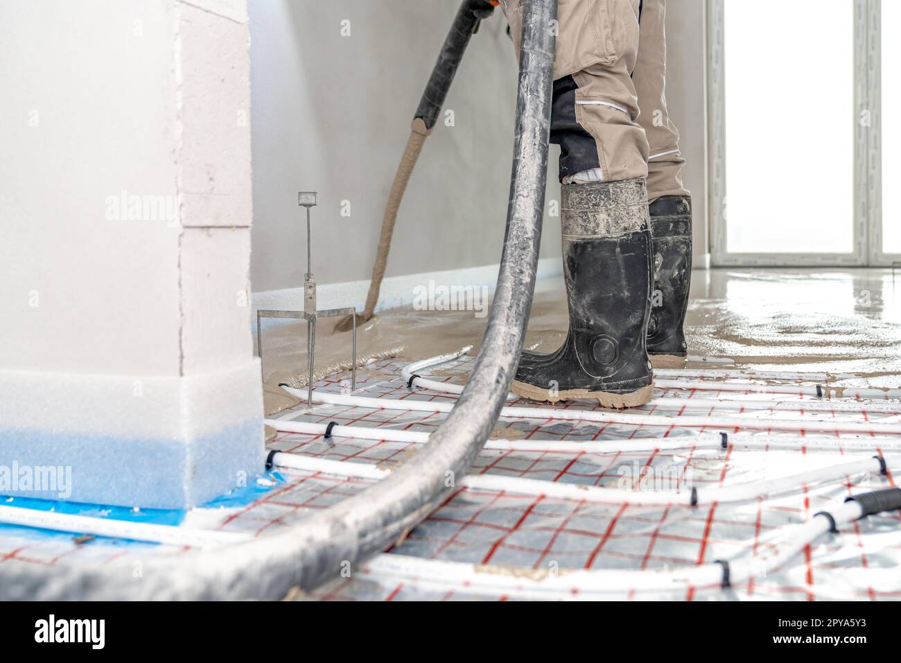installation of liquid concrete on the floor for underfloor heating Stock Photo