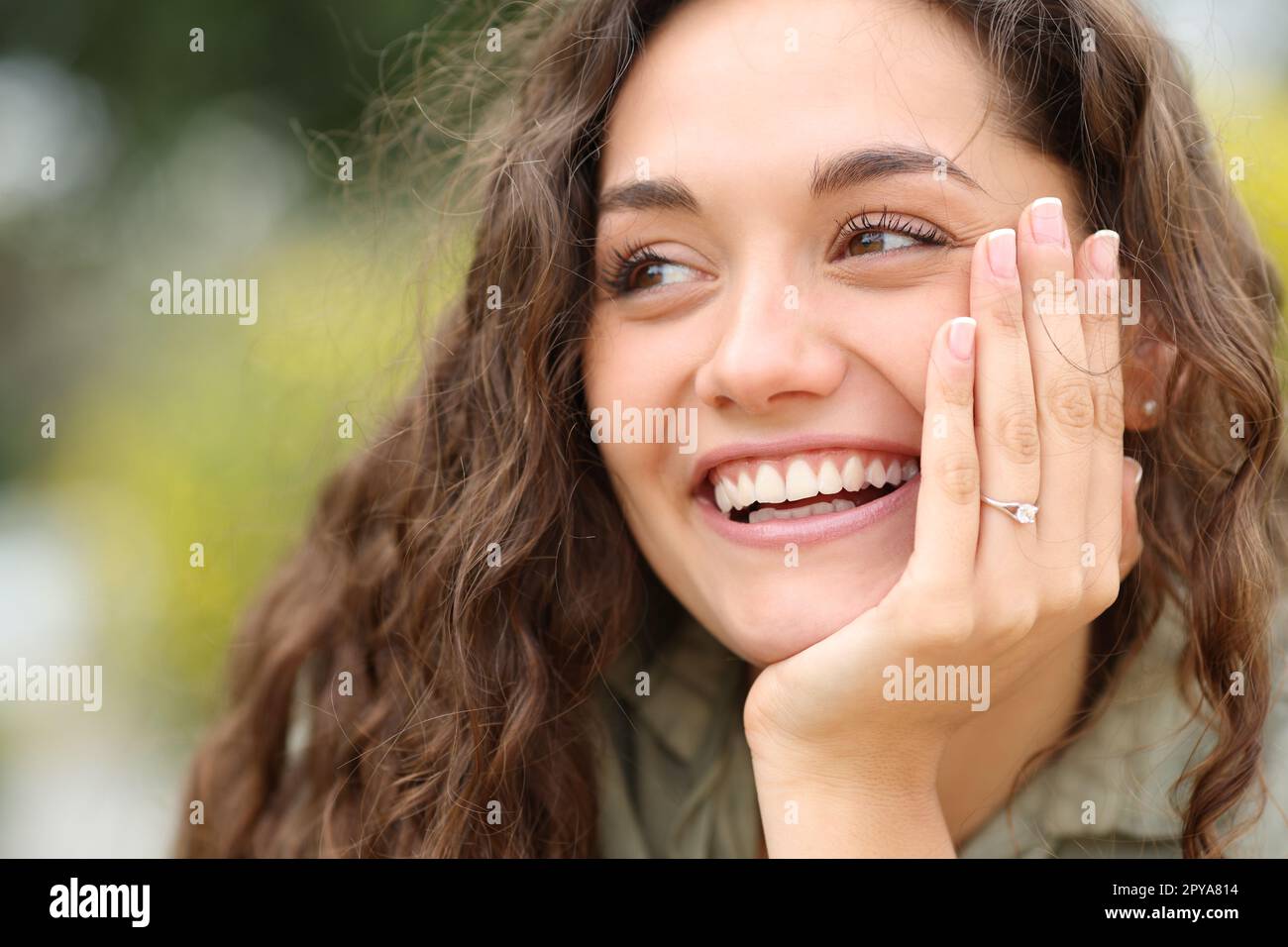 Happy fiencee smiling showing ring at camera Stock Photo - Alamy