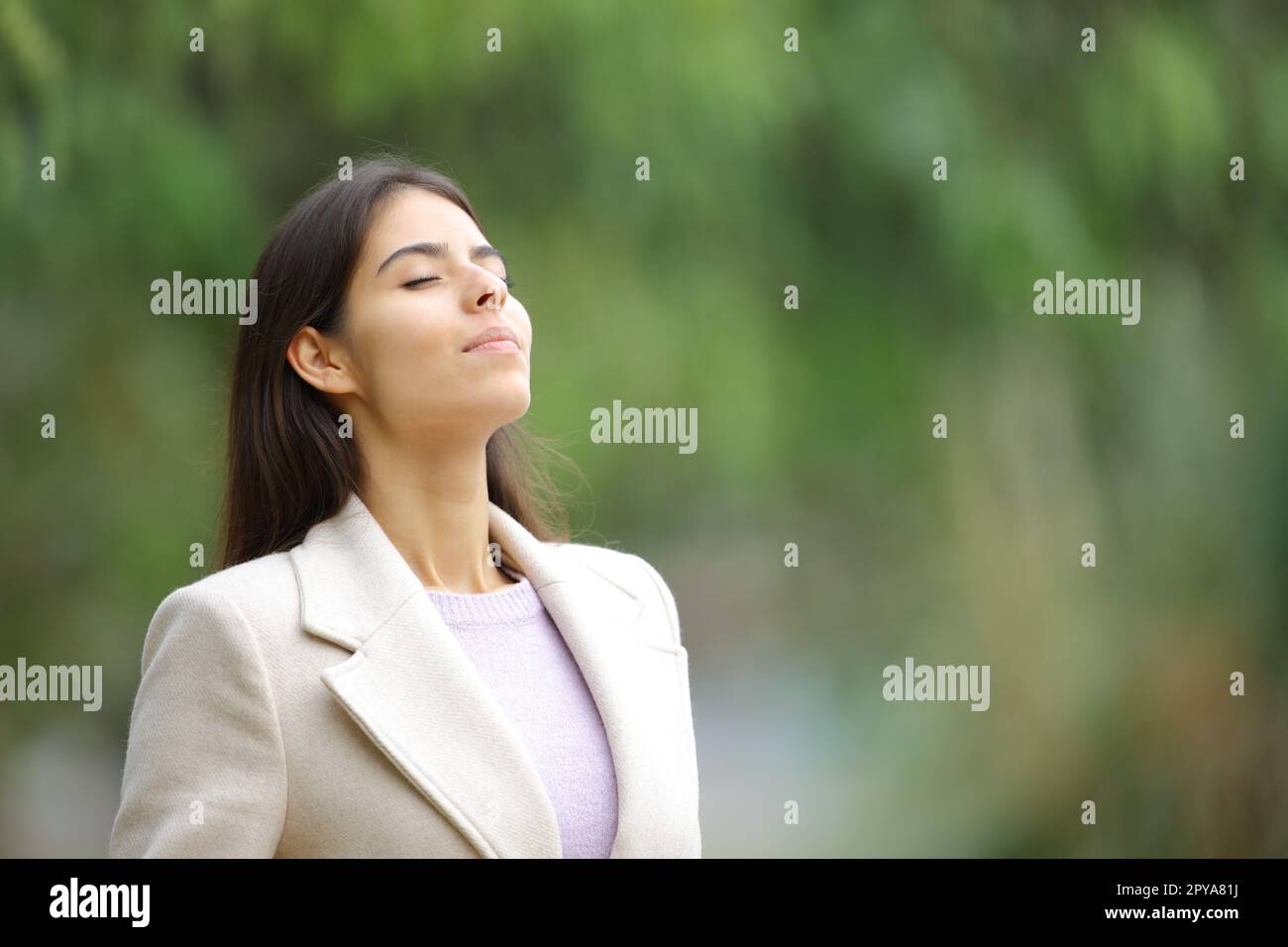 Woman in winter breathing fresh air in nature Stock Photo