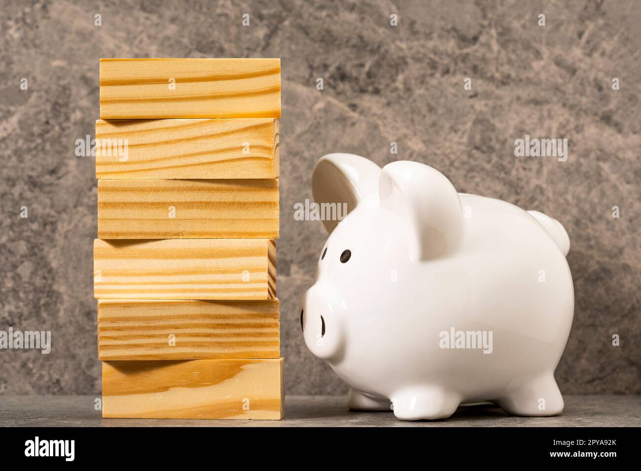 Piggy bank and stack from wooden blocks Stock Photo