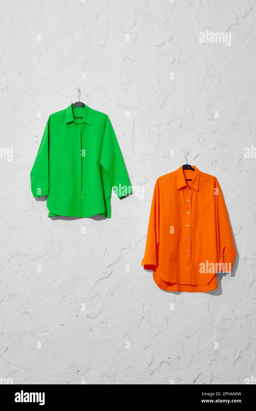 https://c8.alamy.com/comp/2PYAA0W/two-bright-shirts-on-hanger-hang-on-wall-2PYAA0W.jpg