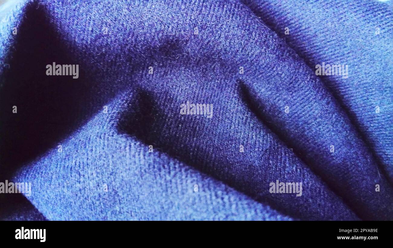 Dark blue fabric that looks like velvet or velveteen. Broken waves. Velor Stock Photo