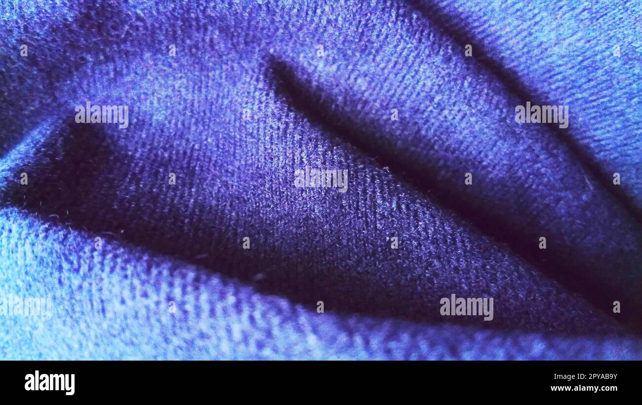 Dark blue fabric that looks like velvet or velveteen. Broken waves. Blue. Violet. Black Stock Photo