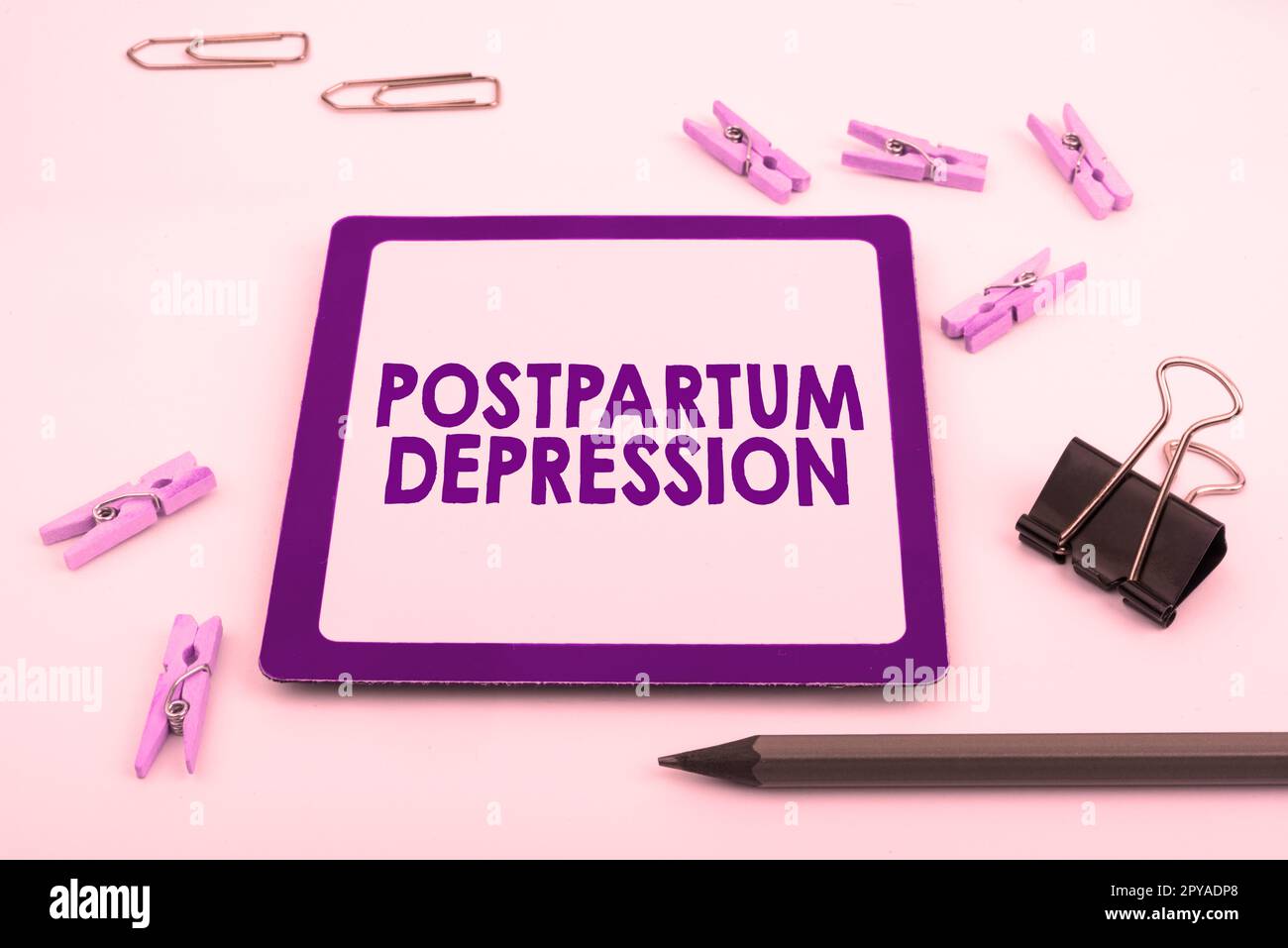 Hand writing sign Postpartum Depression. Word for a mood disorder involving intense depression after giving birth Stock Photo