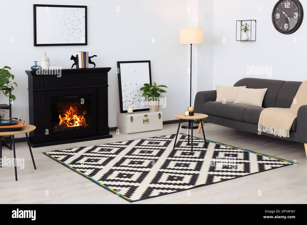 Stylish living room interior with fireplace and comfortable sofa Stock ...