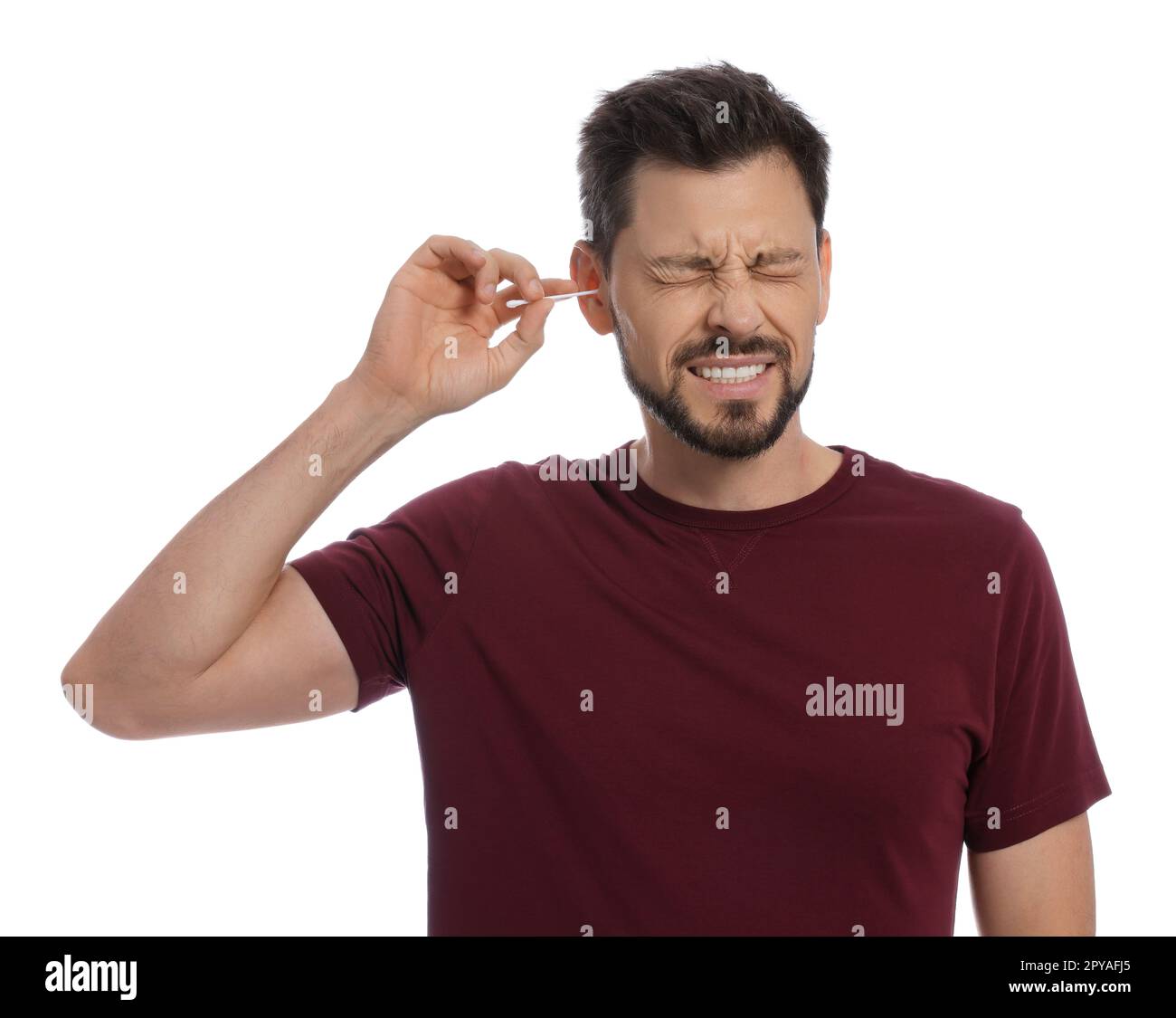 Man cleaning ears and suffering from pain on white background Stock
